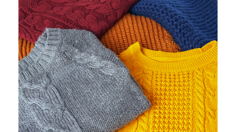 Concept knitted wool colorful warm sweaters closeup