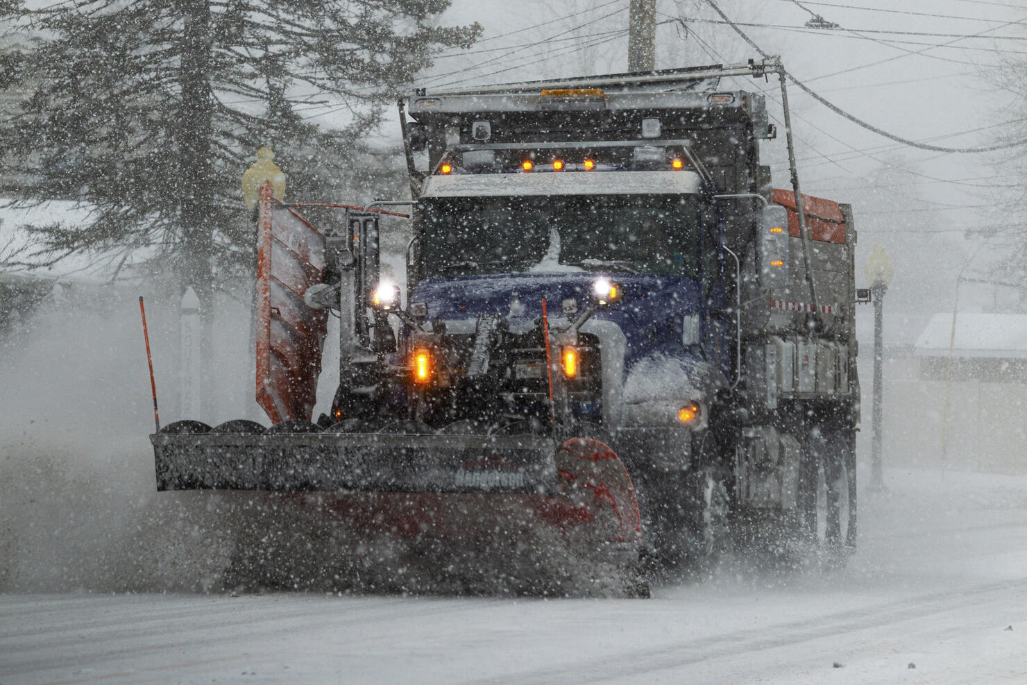 Snowplow clearing the street during a blizzard