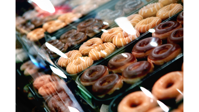 Variety of donuts on a tray in a display case