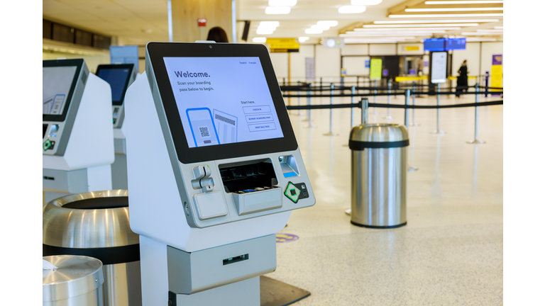 Self service machine desk kiosk at airport for check in printing boarding pass and buying ticket