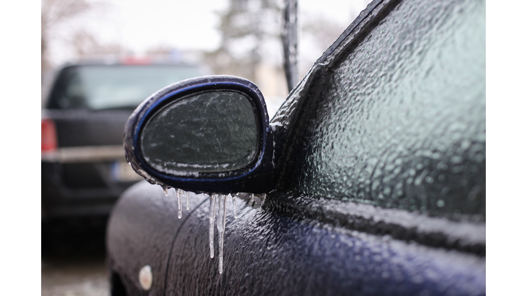 Car frozen side mirror after freezing rain