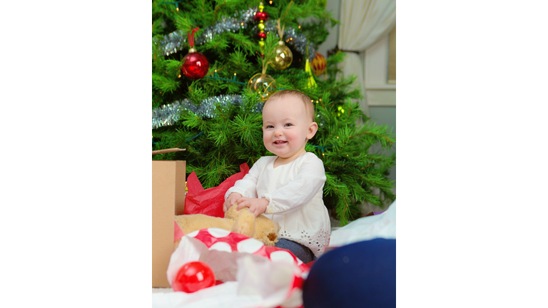 Happy 10 months Old Baby with Christmas Tree and Gift