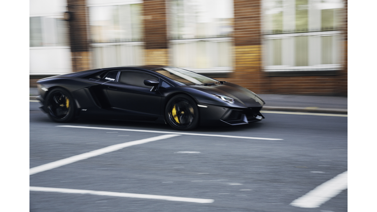 Black Lamborghini sports car in motion