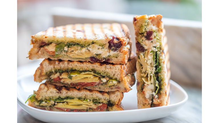 Stacked Vegetarian Sandwiches of Arugula, Artichoke, Sun Dried Tomato, Pesto