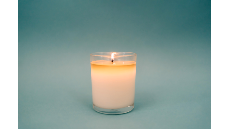 Burning candle on gray background. Set for aromatherapy and rituals. Copy space for your design. Front view