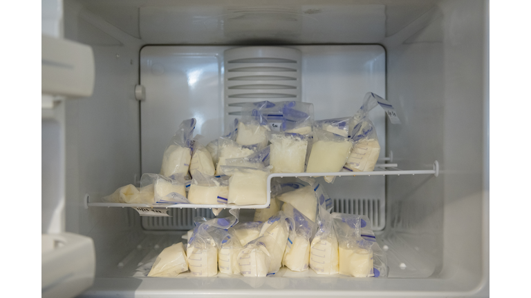 Bags of frozen breast milk in freezer