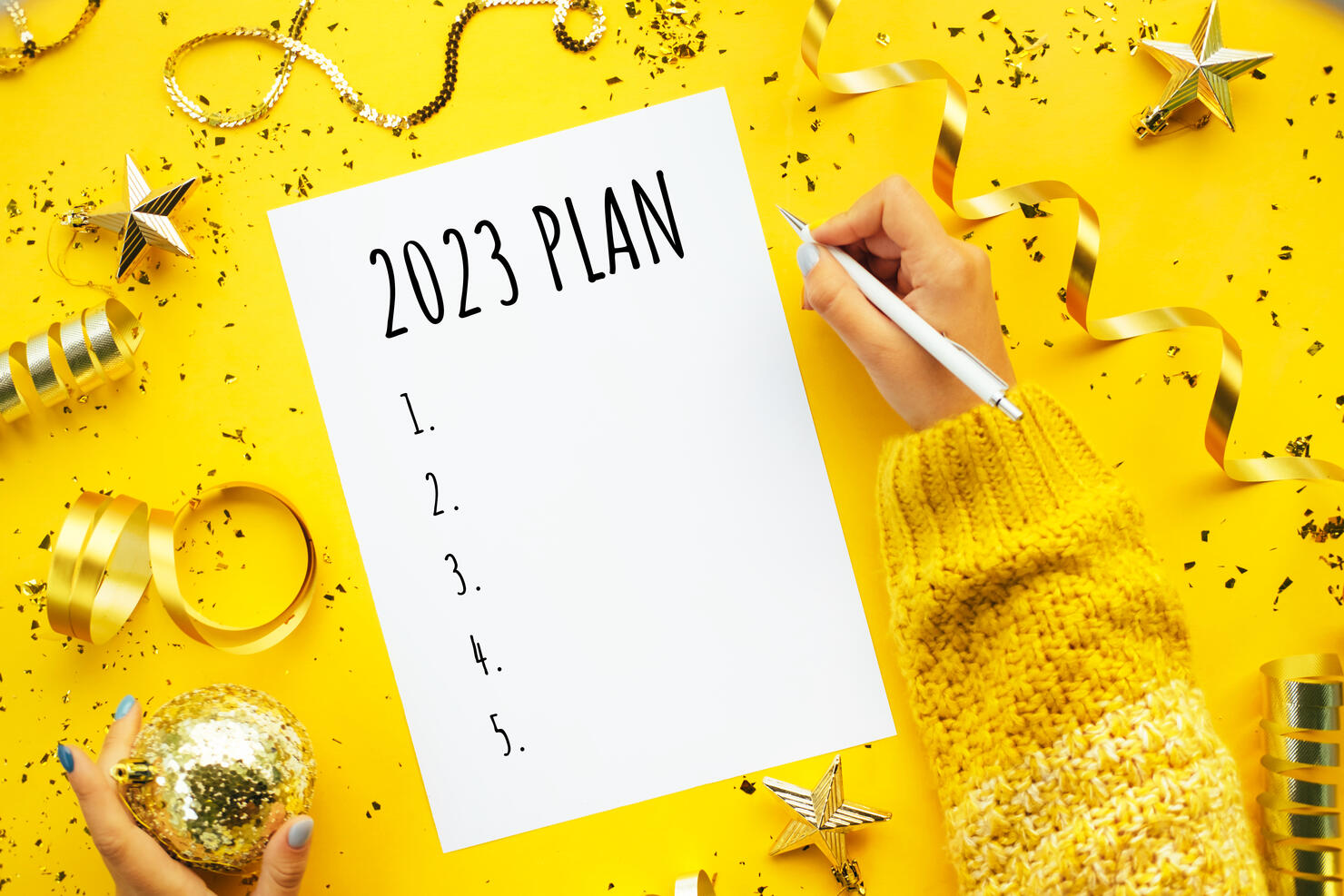 Writing New Year plan 2023. Merry Christmas coming concept. Decorations for Christmas tree on yellow background.