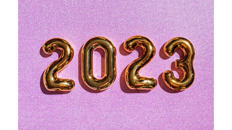 2023 Happy New Year on purple background with glitter