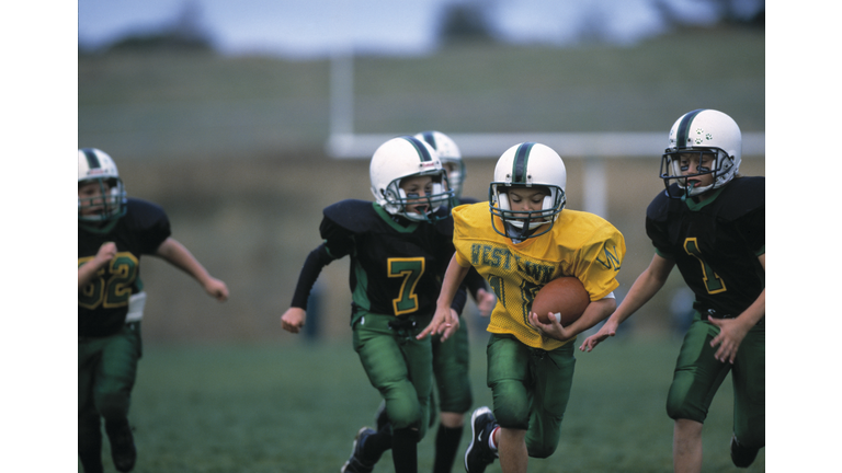 Football Player Runs With Ball