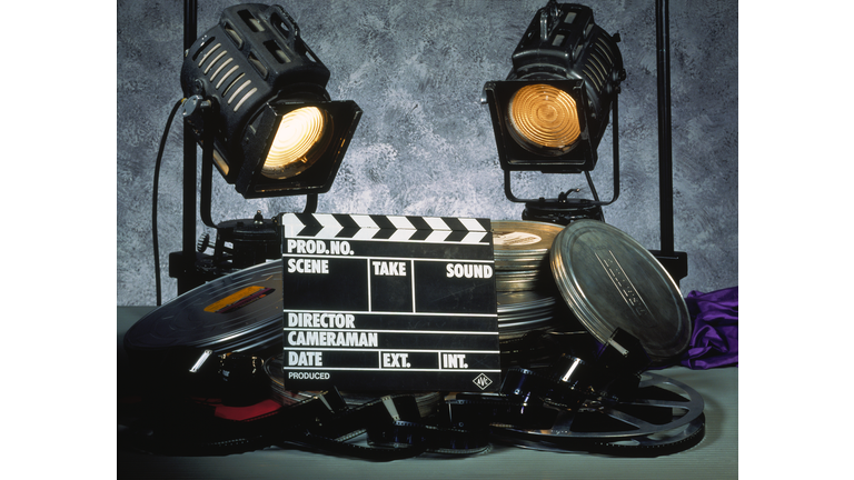 Clapperboard, film and two floodlights