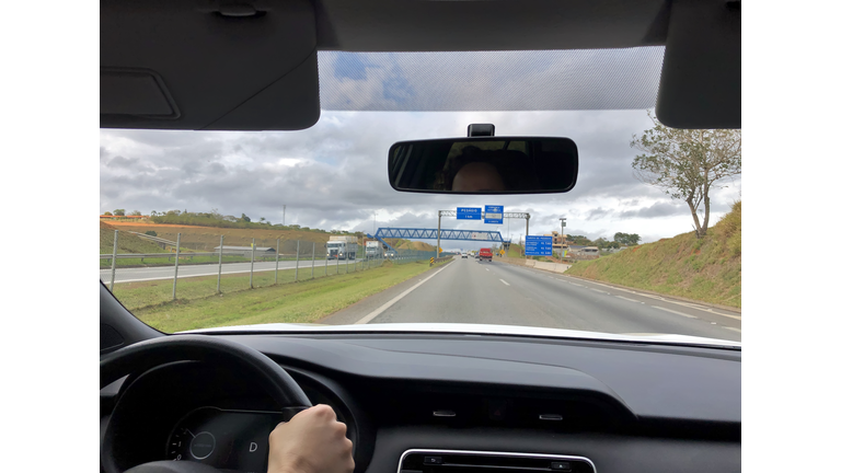 Point of view of a woman driver at the highway