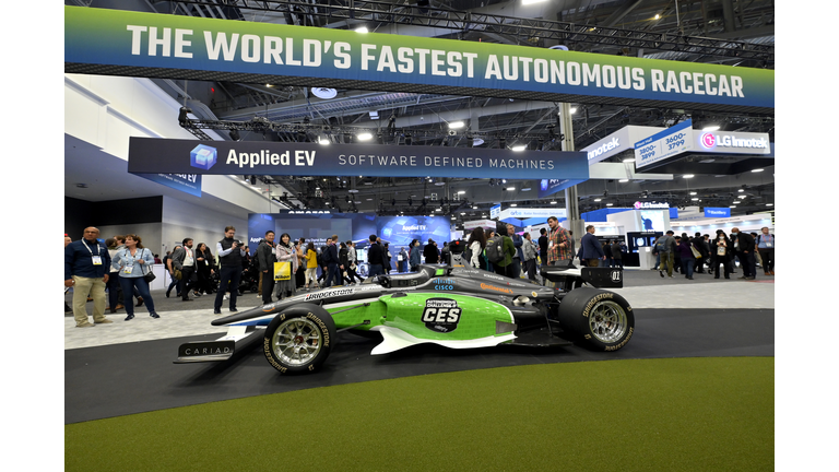 Indy style race car in green and white on display at the CES 2023 show.