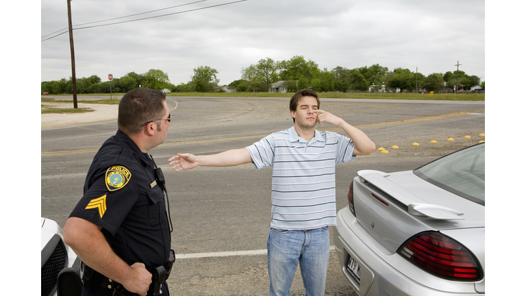 Police officer taking sobriety test of man