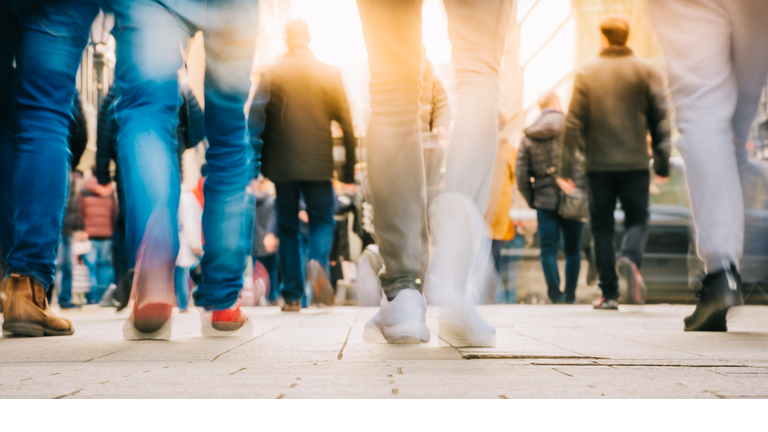 Low Section Of People Walking On Street In City