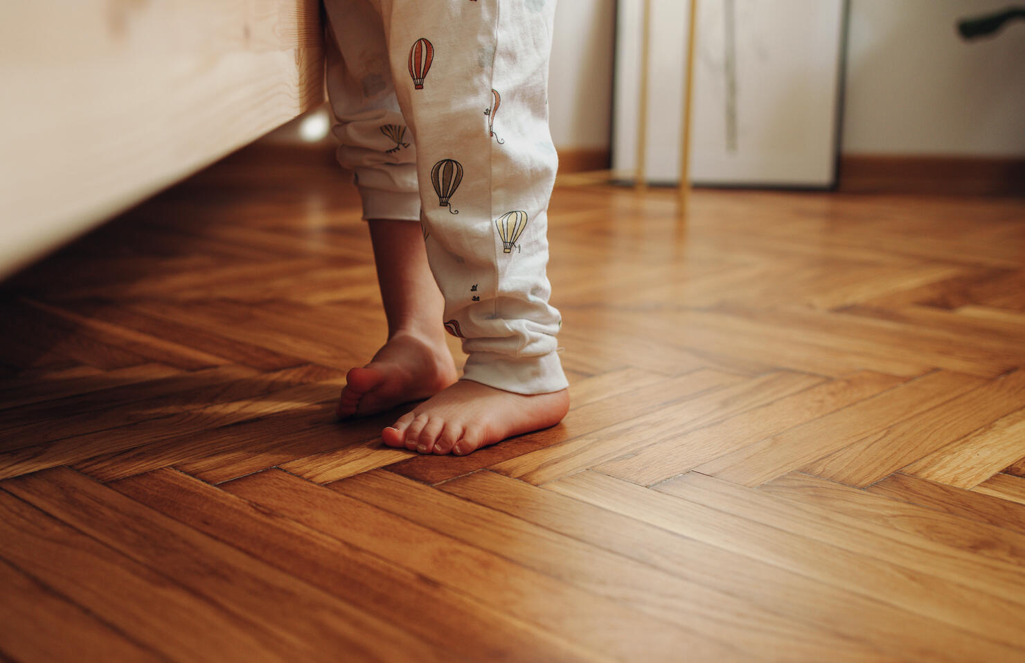 Close Up Shot of Child's Legs on the Wooden Floor