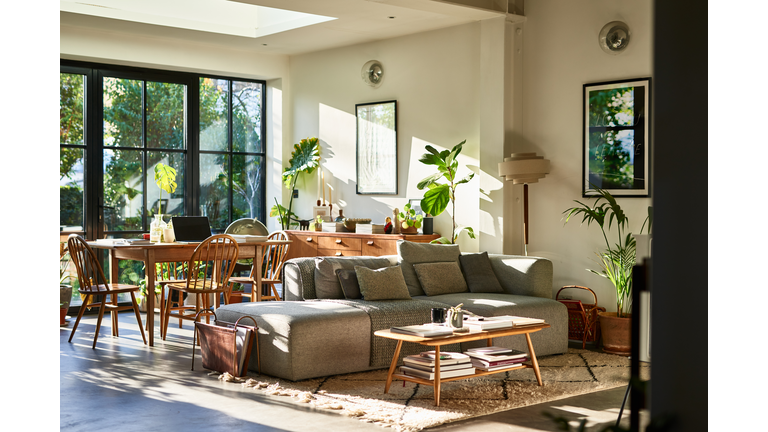 Open plan living space in residential house with natural light and retro furniture
