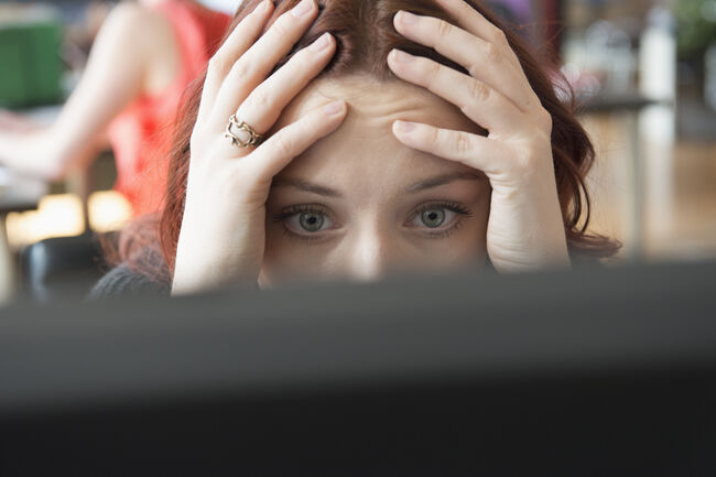 Frustrated businesswoman using computer