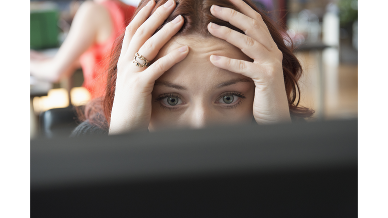 Frustrated Caucasian businesswoman using computer