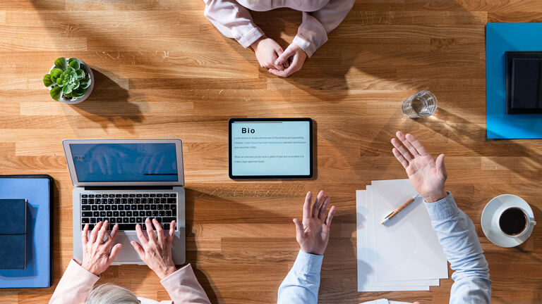 Top view of group of business people working at desk, job interview.