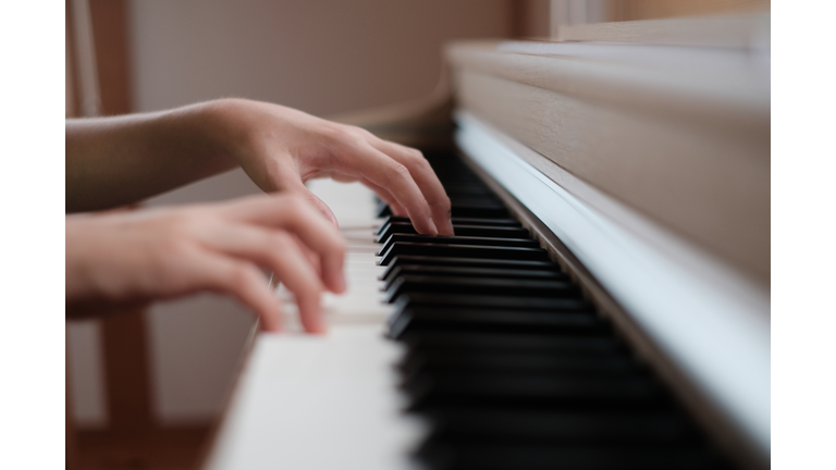Close up hands playing piano