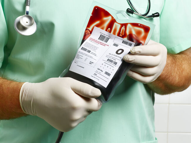 Doctor/ Nurse holding blood bag.