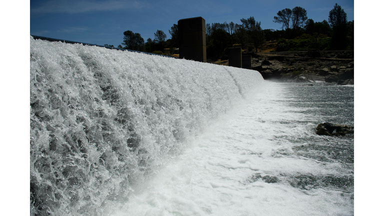 Water pouring over a dam.