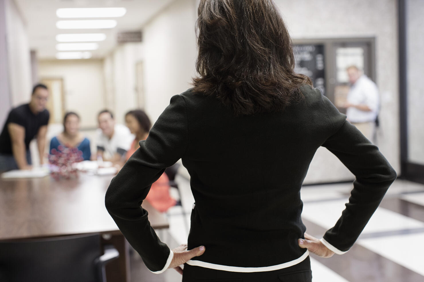 Teacher watching students in hallway