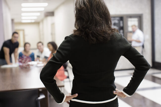 Teacher watching students in hallway