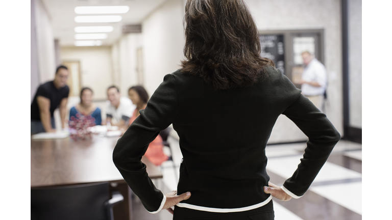 Teacher watching students in hallway