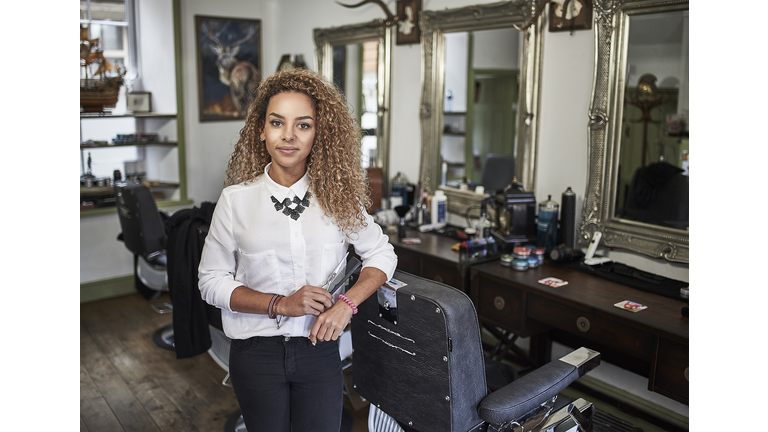 Portrait of young female barber