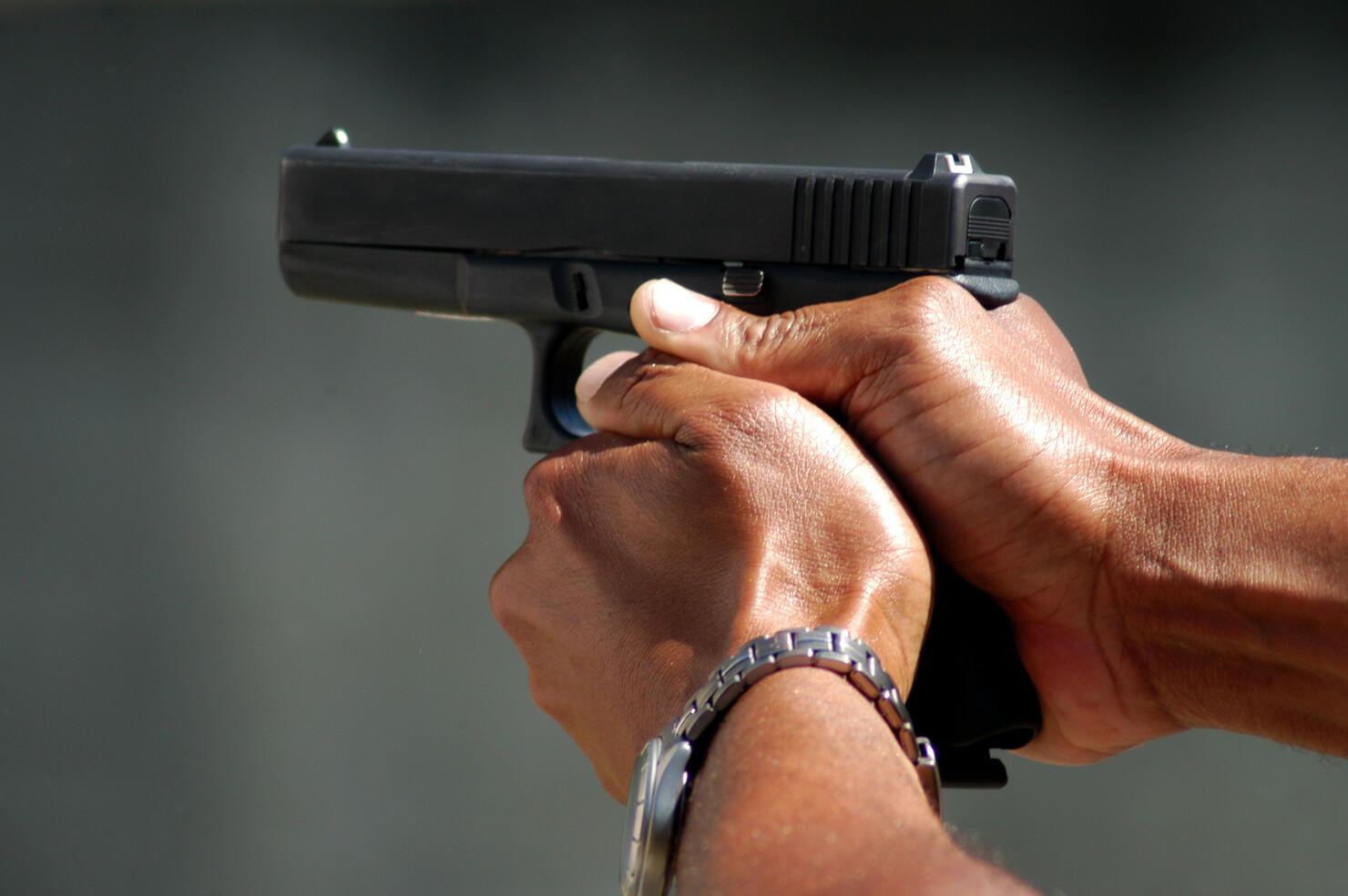 Cropped Hands Aiming With Gun