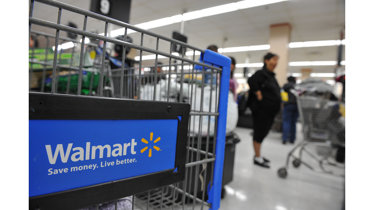 Shoppers wait in line to pay for their p