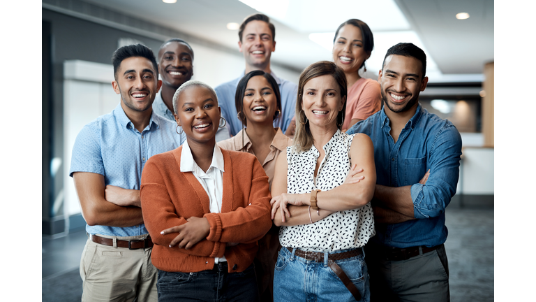 Portrait of a group of confident young businesspeople working together in a modern office