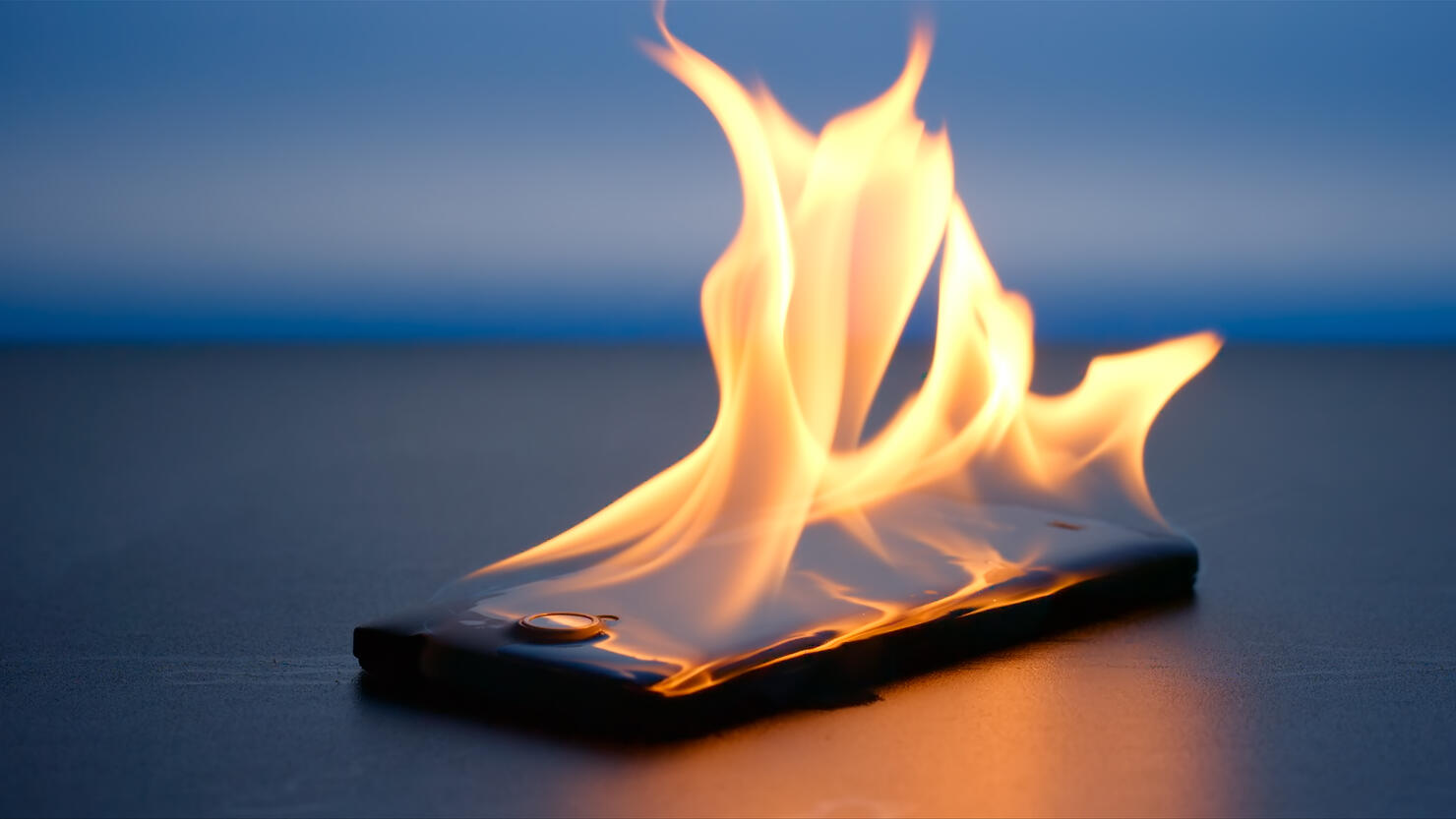 Smartphone lies and burning on a table in the night