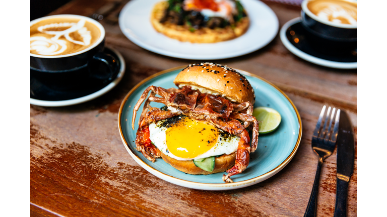 Breakfast in a cafe with crab burger and sunny side up egg