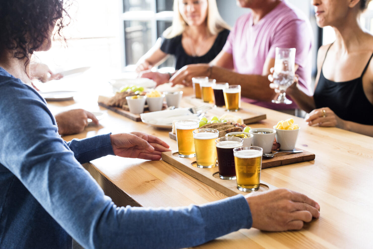 Group Of Friends Enjoying Lunch & Craft Beer Tasting
