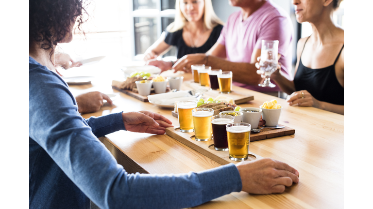 Group Of Friends Enjoying Lunch & Craft Beer Tasting