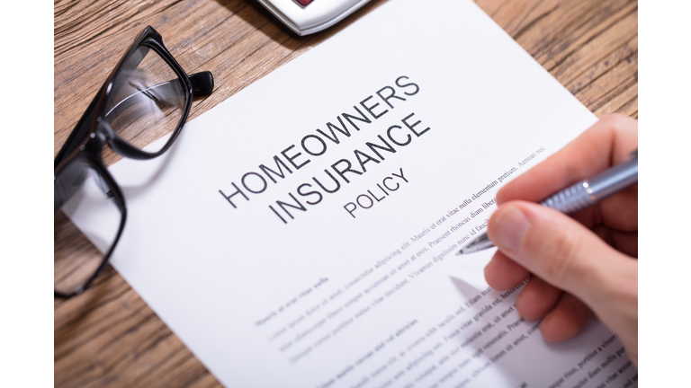 Person Filling Homeowners Insurance Policy Form