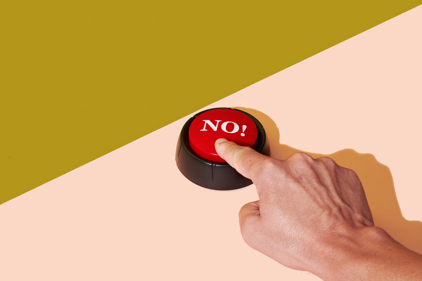 man pushing a red button with the word no