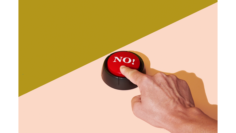 man pushing a red button with the word no