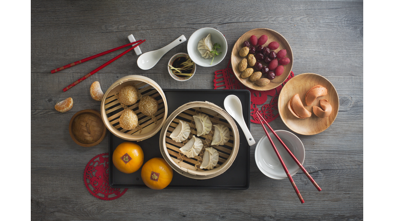 Chinese food steamed dumpling and tea served on rustic wooden background.