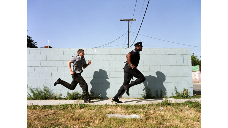 Man chasing police officer down sidewalk