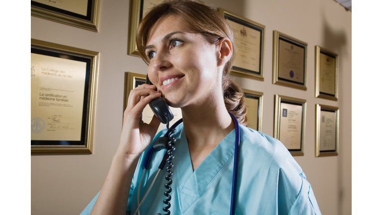 Nurse answering the phone at reception