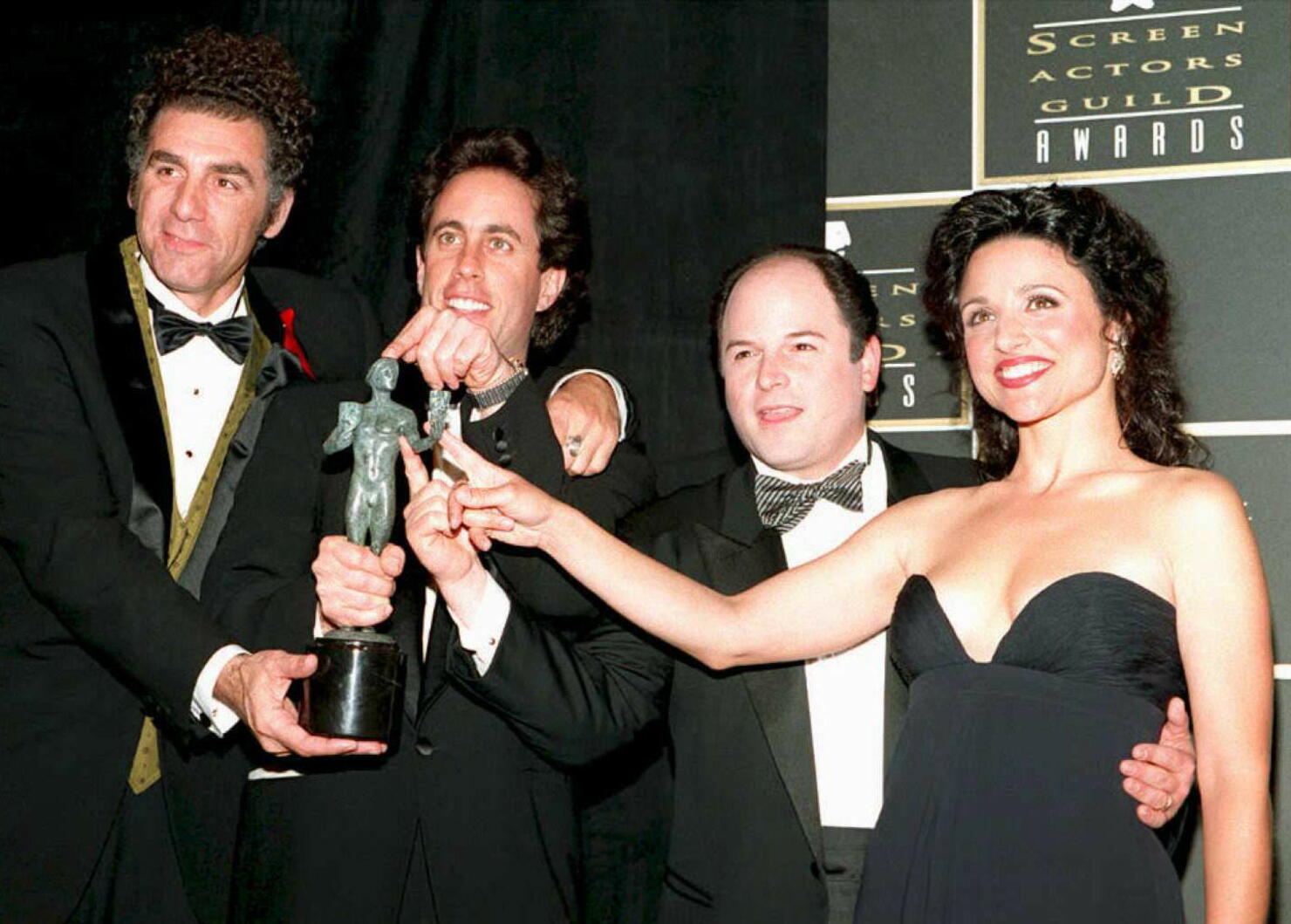 The cast of "Seinfeld" plays with the award they w
