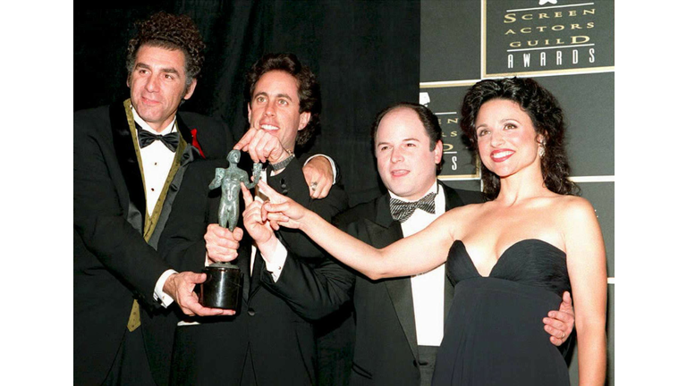 The cast of "Seinfeld" plays with the award they w