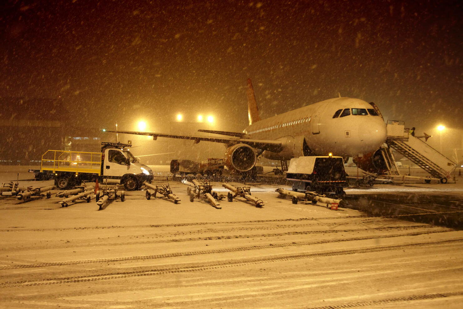 Aircraft in snow blizzard at airport
