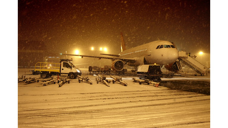 Aircraft in snow blizzard at airport