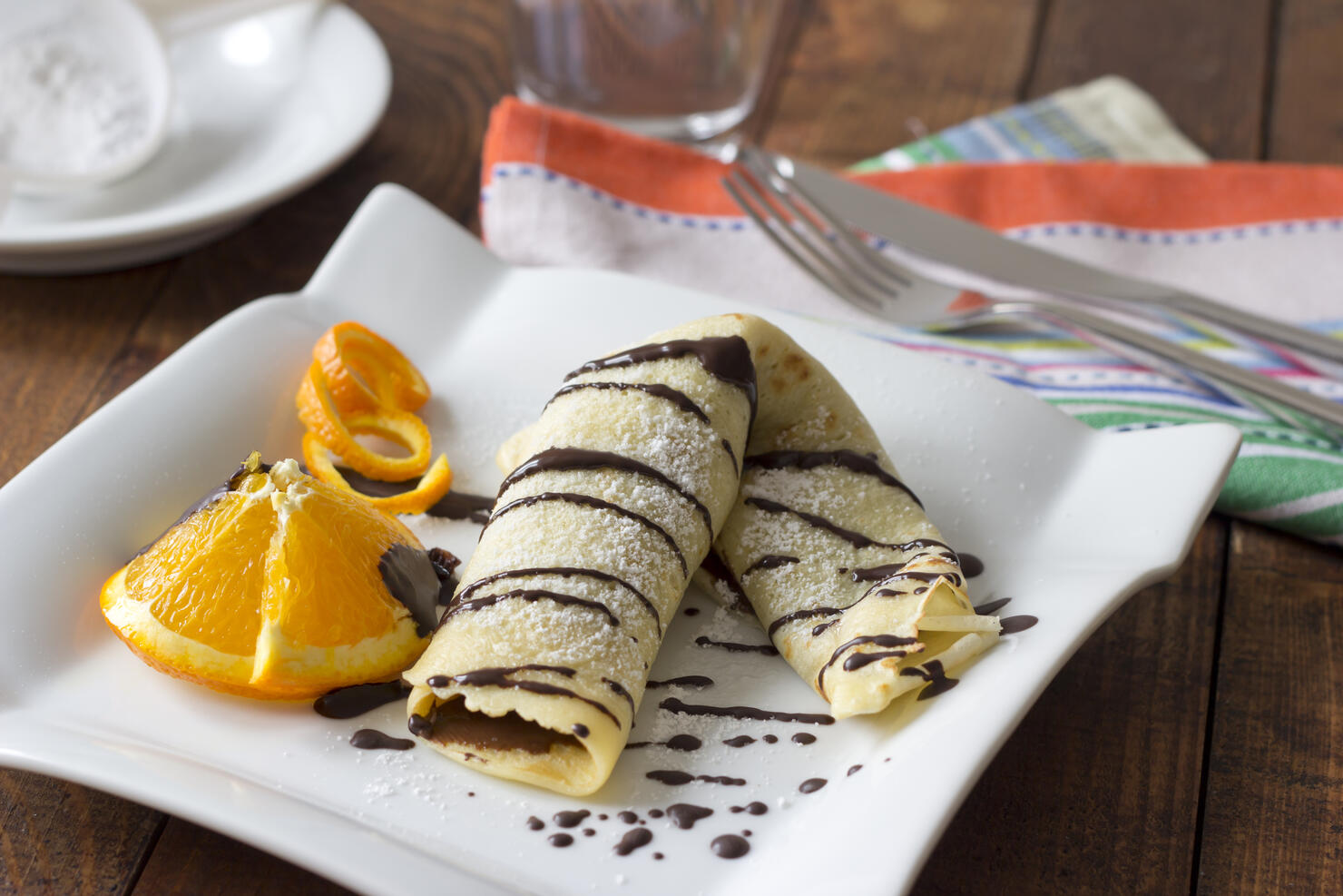Pancake filled with chocolate cream on plate