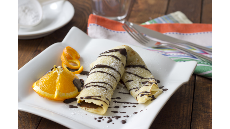 Pancake filled with chocolate cream on plate