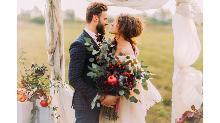 Wedding couple lovingly look at each other during  ceremony